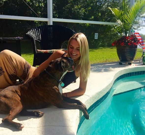 Kesley Owens in her house, near pool with her doggy