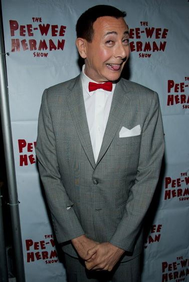 Paul Reubens posing in front of The Pee-wee Herman show flex